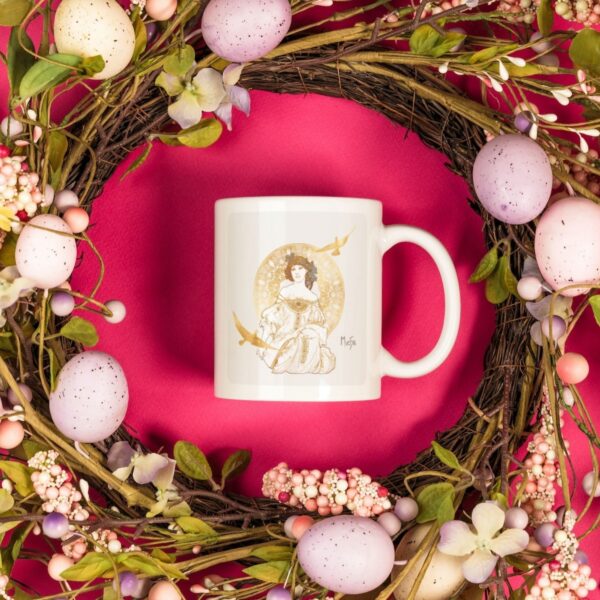 Easter-themed wreath surrounds art mug on pink background.