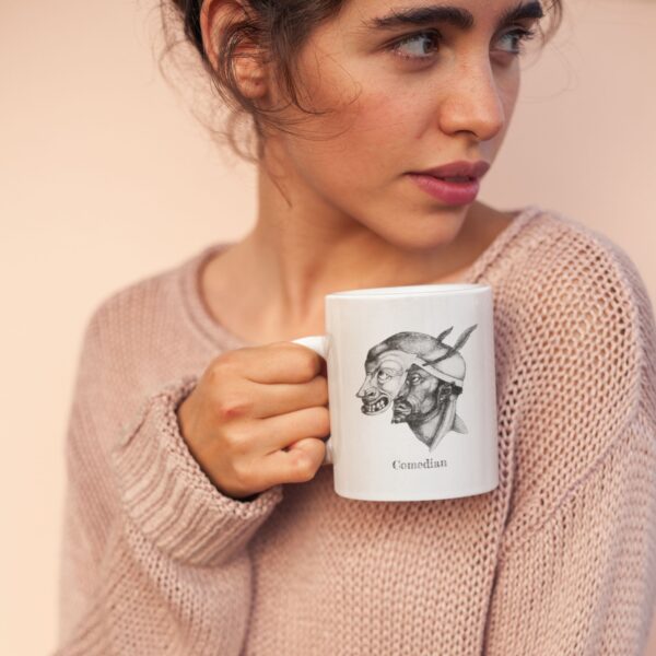 Woman holding art-decorated mug, neutral background.