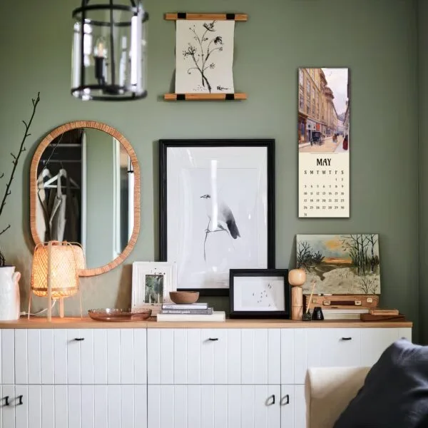 Stylish living room with art and calendar on wall.