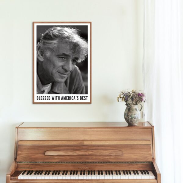 Framed portrait of Leonard Bernstein above a wooden upright piano.