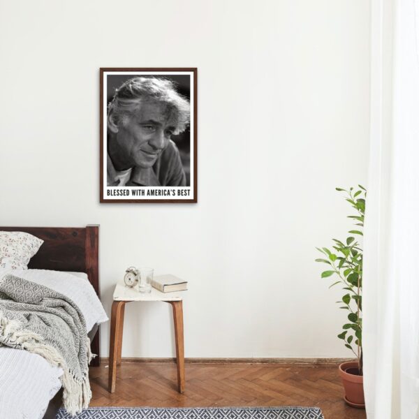 Cozy bedroom with black-and-white portrait of Leonard Bernstein on wall.