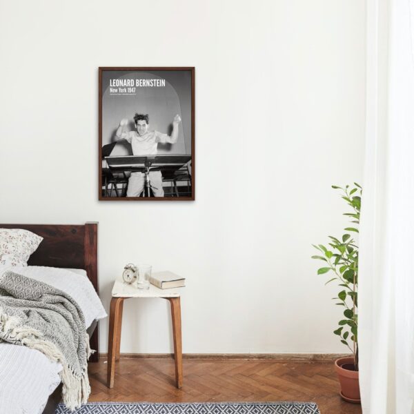 Bedroom with framed Leonard Bernstein poster on wall.