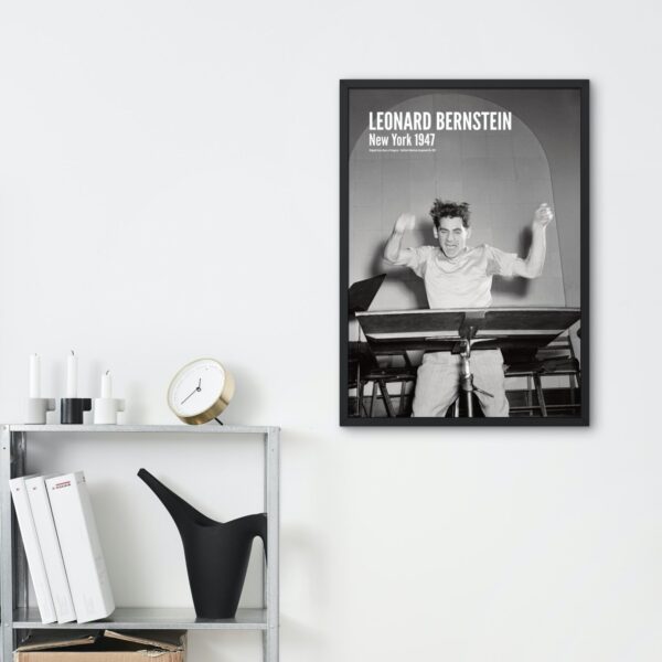 Framed 1947 photo of Leonard Bernstein on modern shelf display.