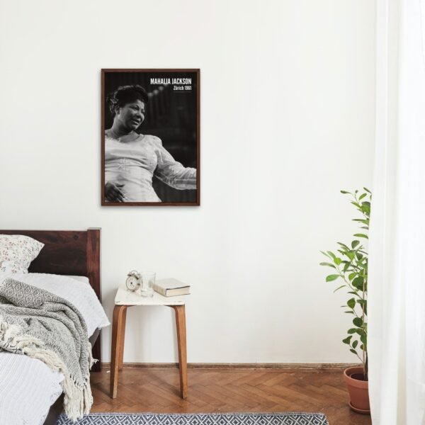 Bedroom with framed photo and plant on floor.