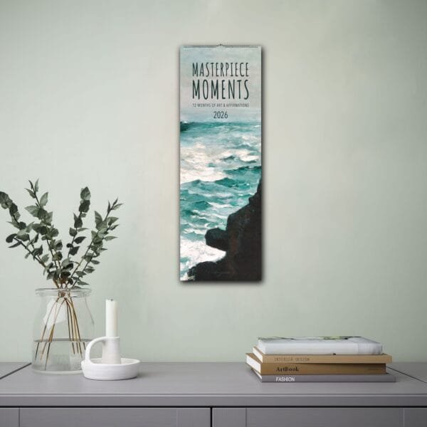 Calendar on wall above modern desk setup.