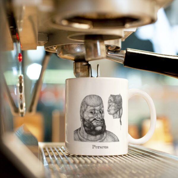 Mug with ancient face design under coffee machine