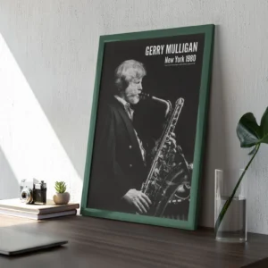 Framed saxophonist Gerry Mulligan poster on wooden desk.