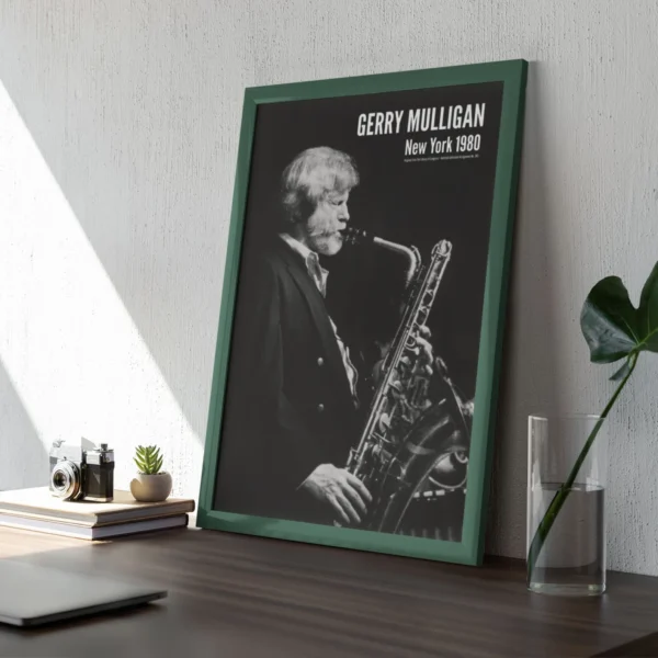 Framed saxophonist Gerry Mulligan poster on wooden desk.