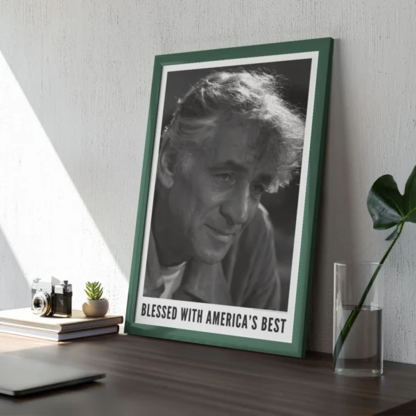 Framed black and white portrait of Leonard Bernstein on tabletop.