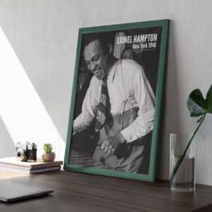 Framed black and white photo of Lionel Hampton on desk, sunlight.