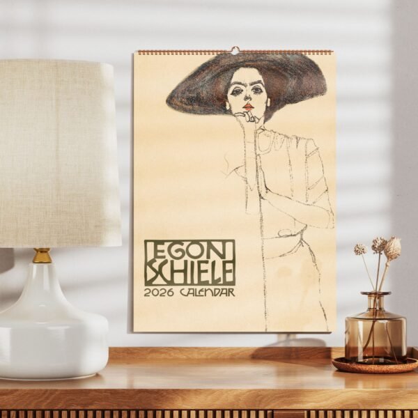 Egon Schiele 2026 calendar on wooden table display.