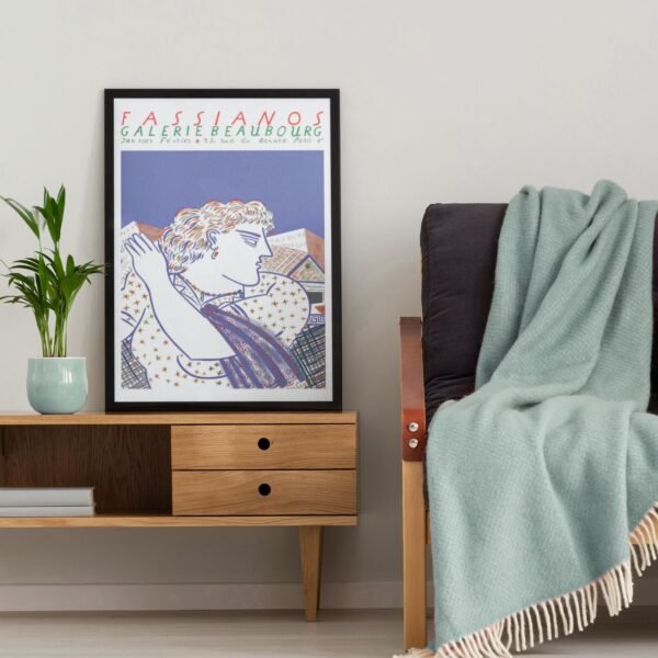 Art poster on wooden side table with plant.