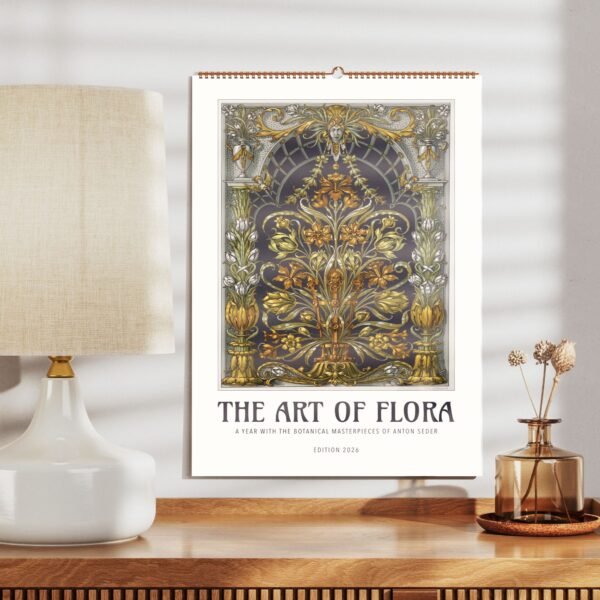 Floral art calendar beside lamp and vase on table.