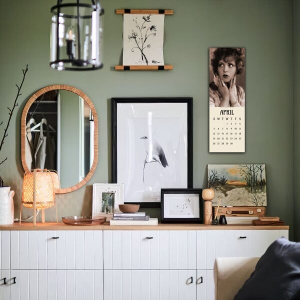 Decorative wall with framed art and calendar display.