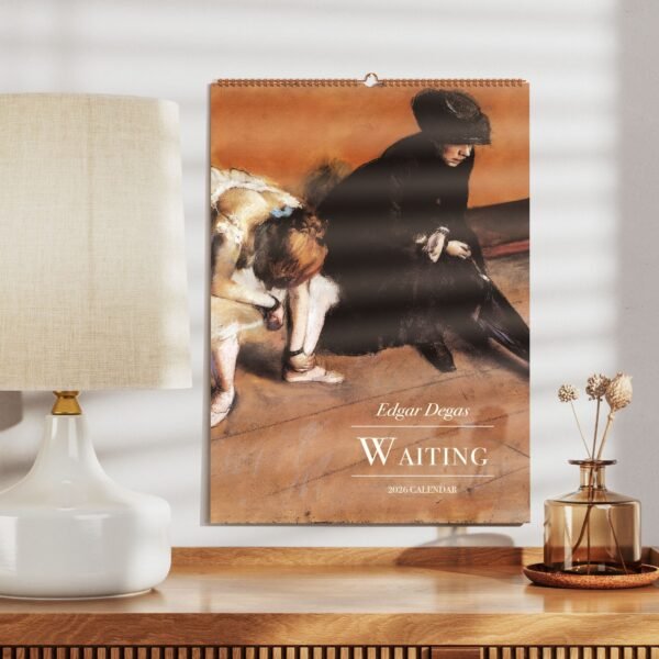 Edgar Degas 2026 calendar on a wooden shelf.
