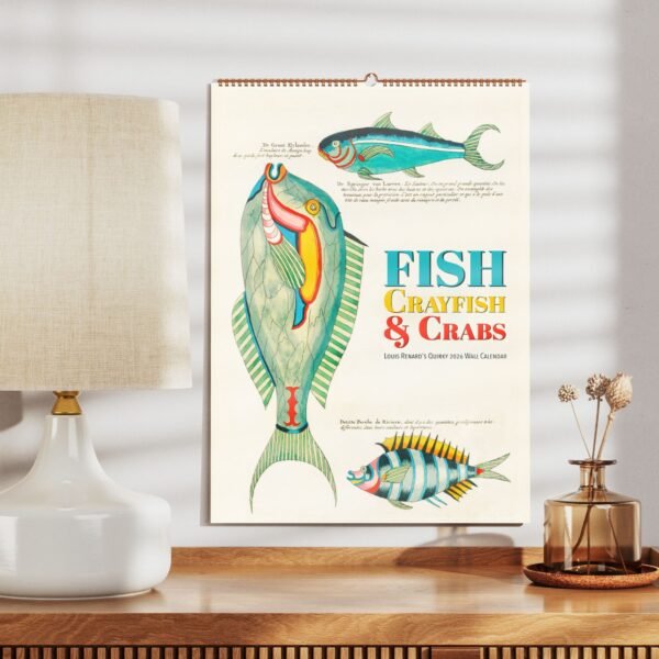 Fish-themed 2024 wall calendar on wooden table.