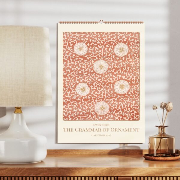 Ornamental calendar 2026 with floral design on table.