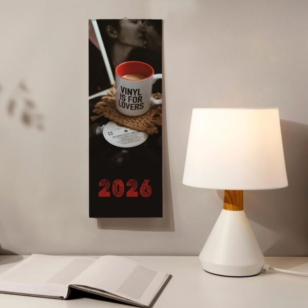 2026 calendar with mug and book by lamp.
