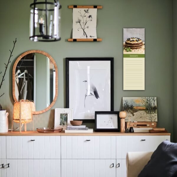 Styled white cabinet with framed art and decor.