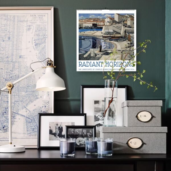 Decorative desk with map, calendar, frames, and lamp.