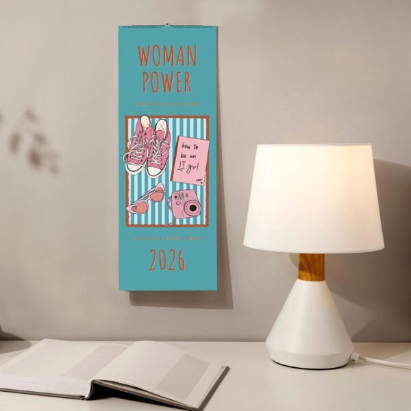 2026 Woman Power calendar next to lamp