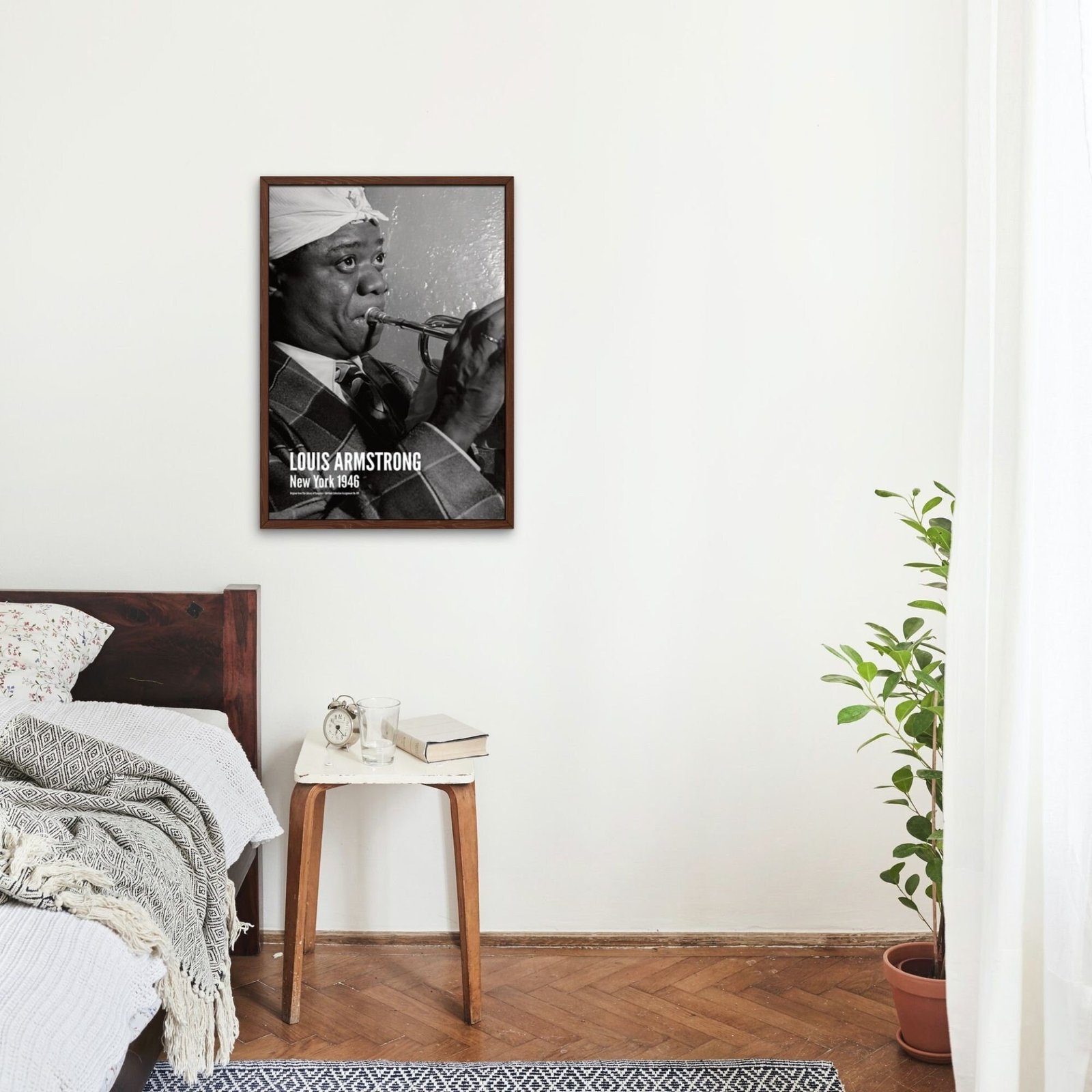 Bedroom with jazz musician poster on wall.