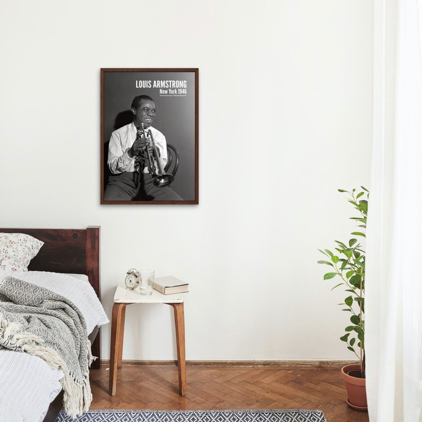 Bedroom with trumpet player's portrait on wall.