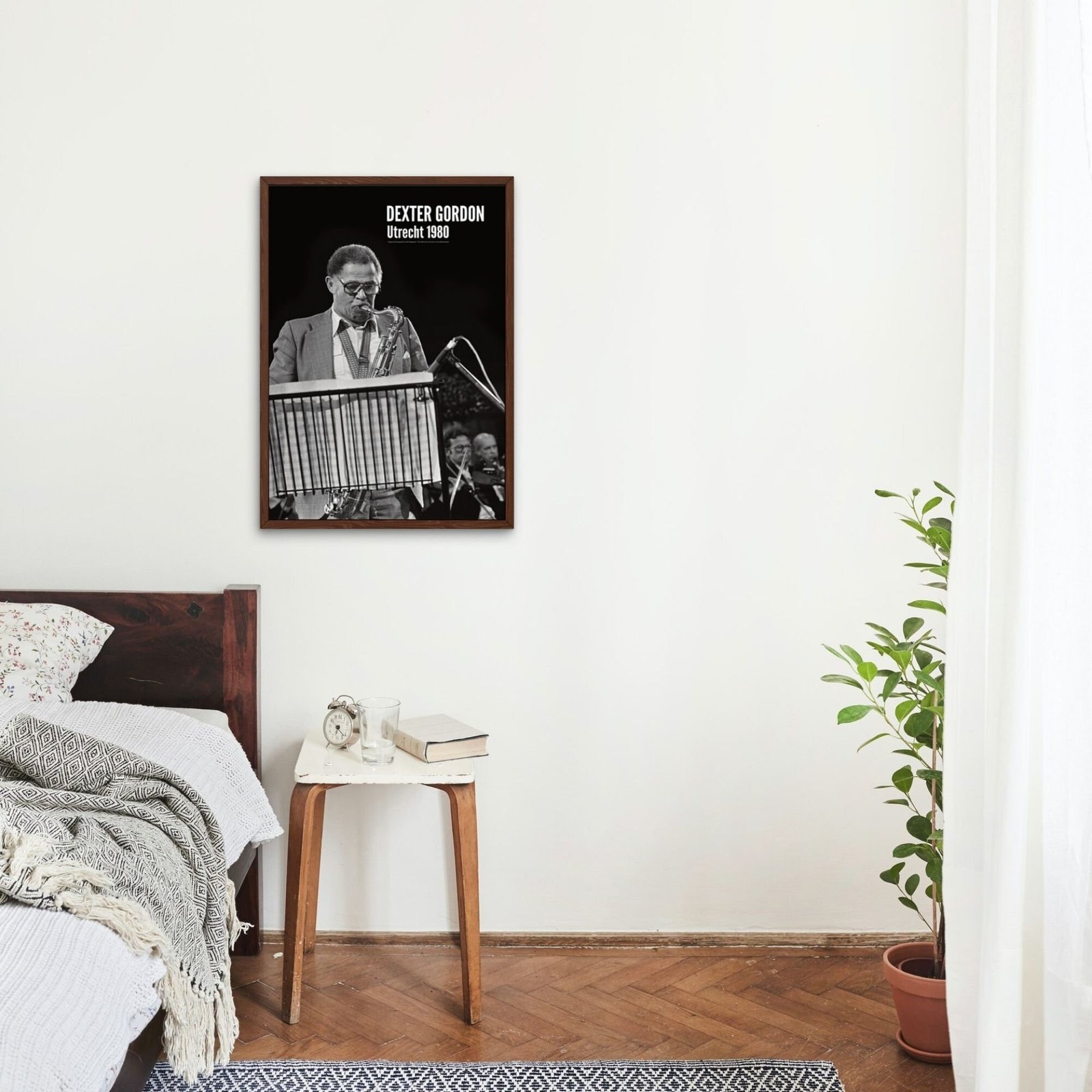 Bedroom with jazz poster and plant decor.