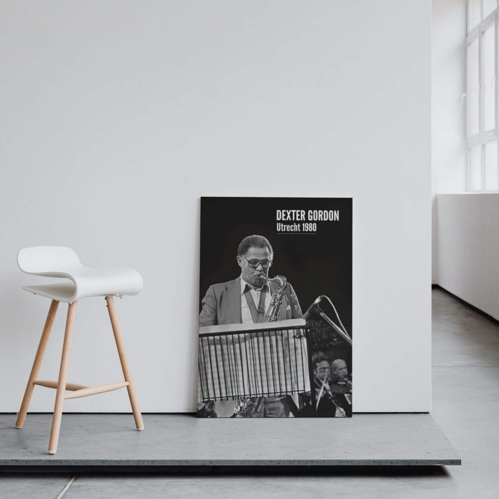 Chair and jazz poster in minimalist room.