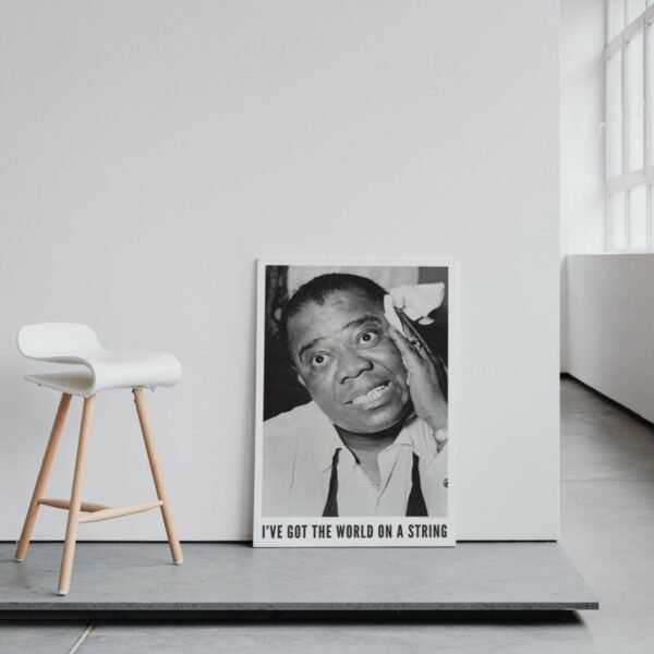 Monochrome portrait poster and modern white chair.
