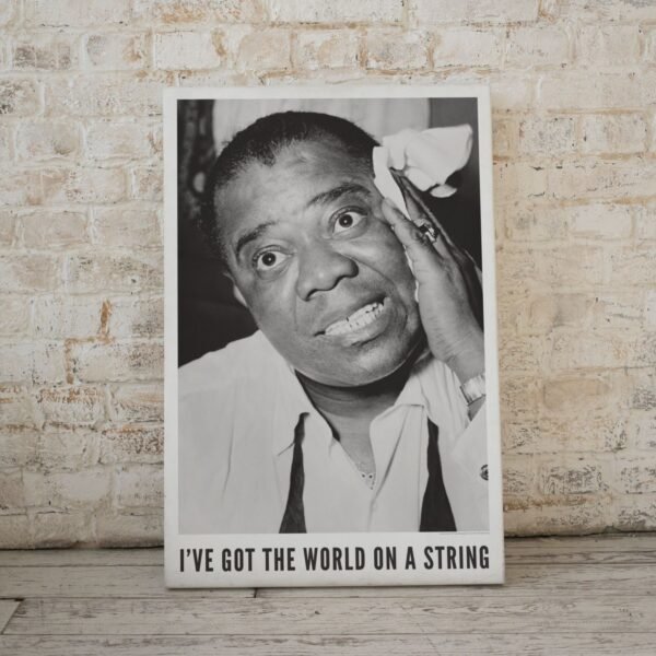 Louis Armstrong wiping face with towel, smiling.