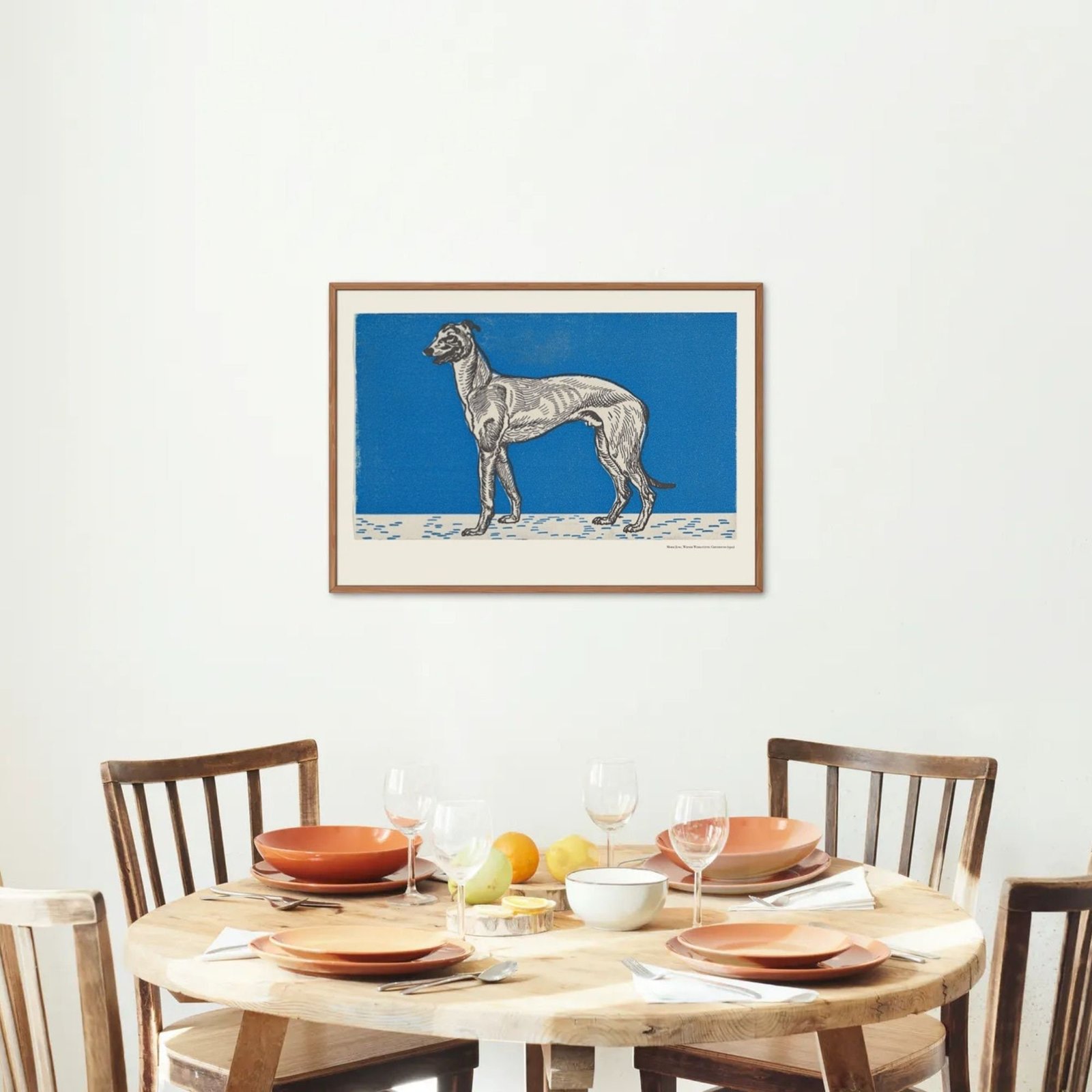 Dining table with dog artwork on wall.