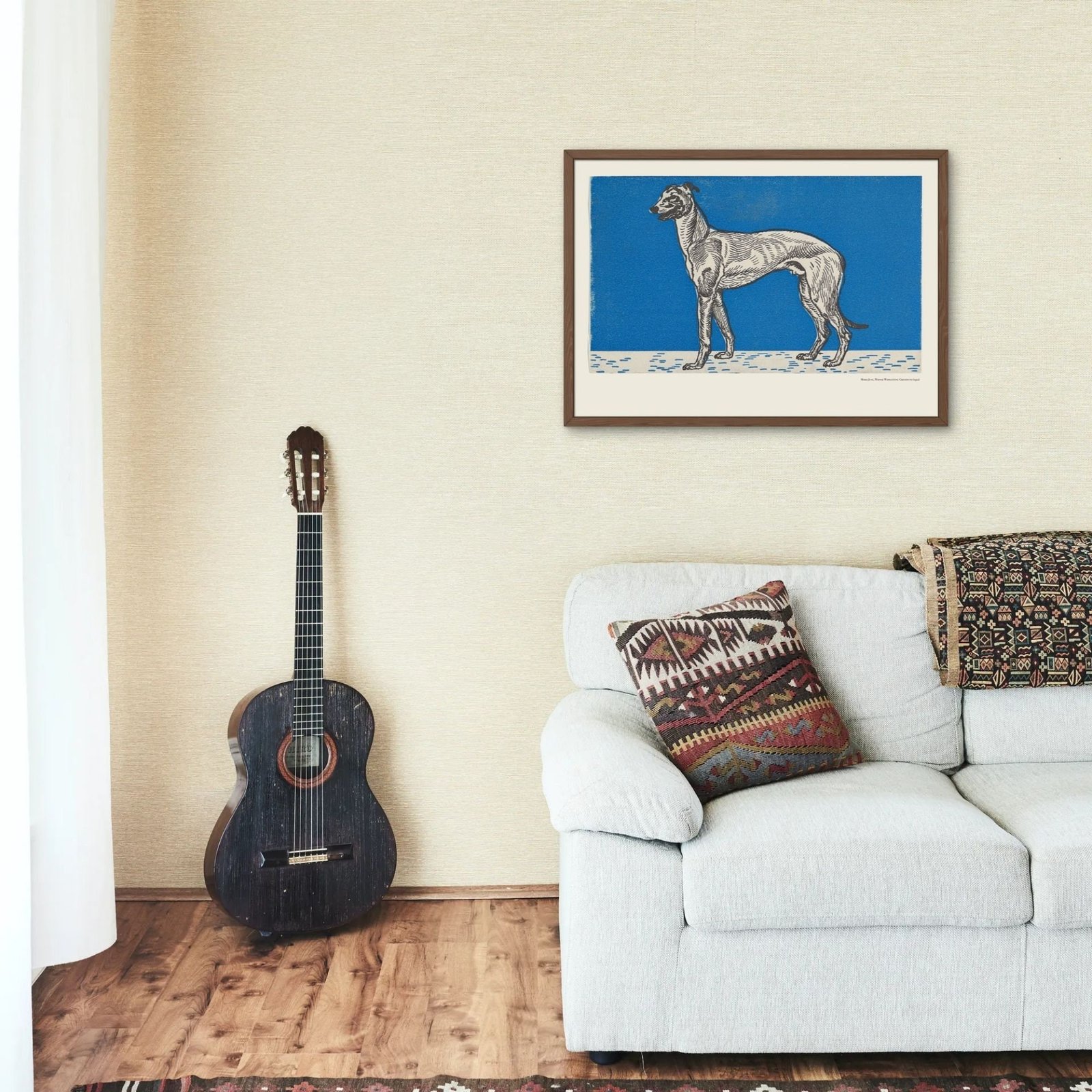 Cozy room with couch, guitar, dog artwork.