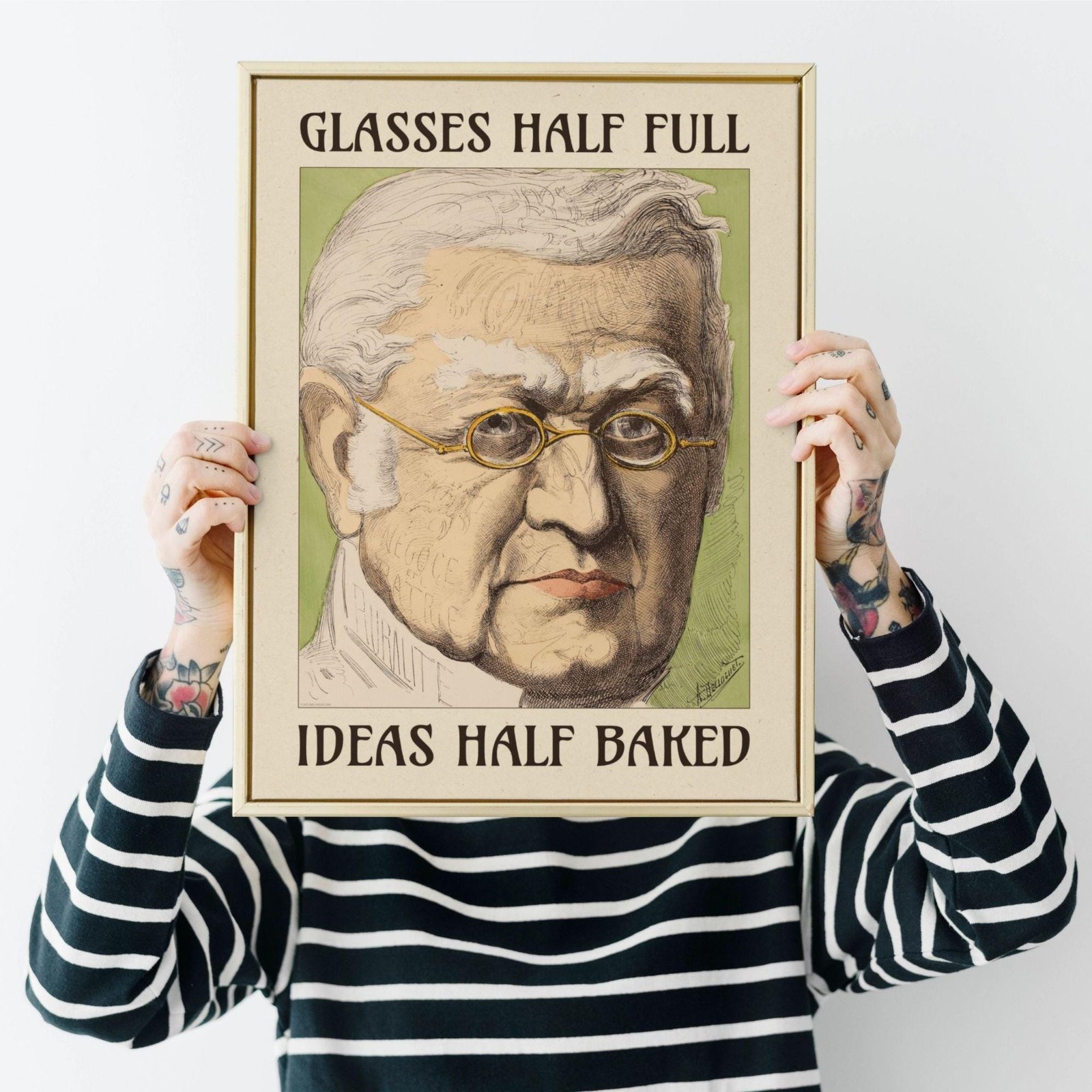 Person holding framed vintage illustration of glasses.