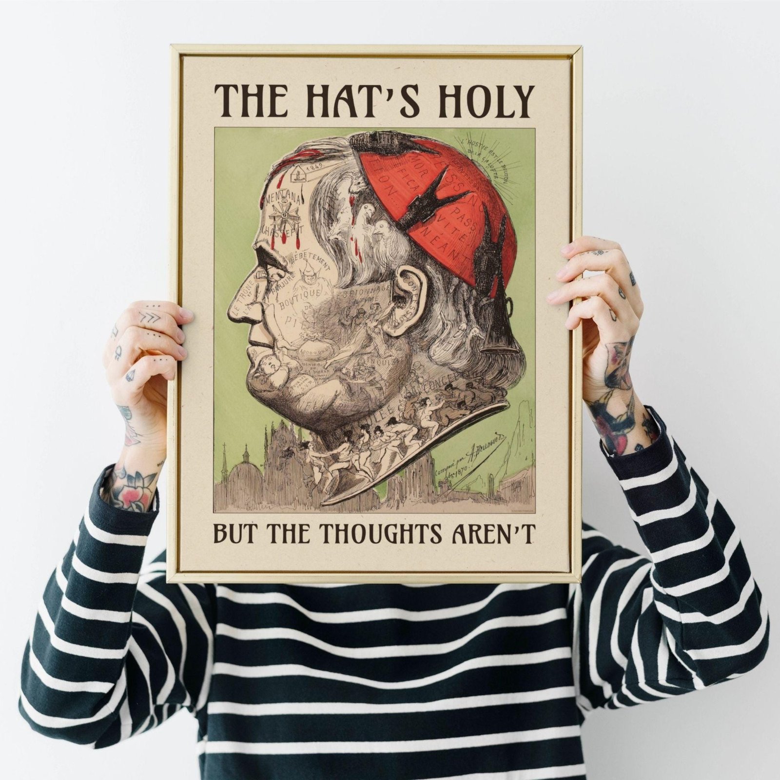 Framed caricature with text 'The Hat's Holy'.