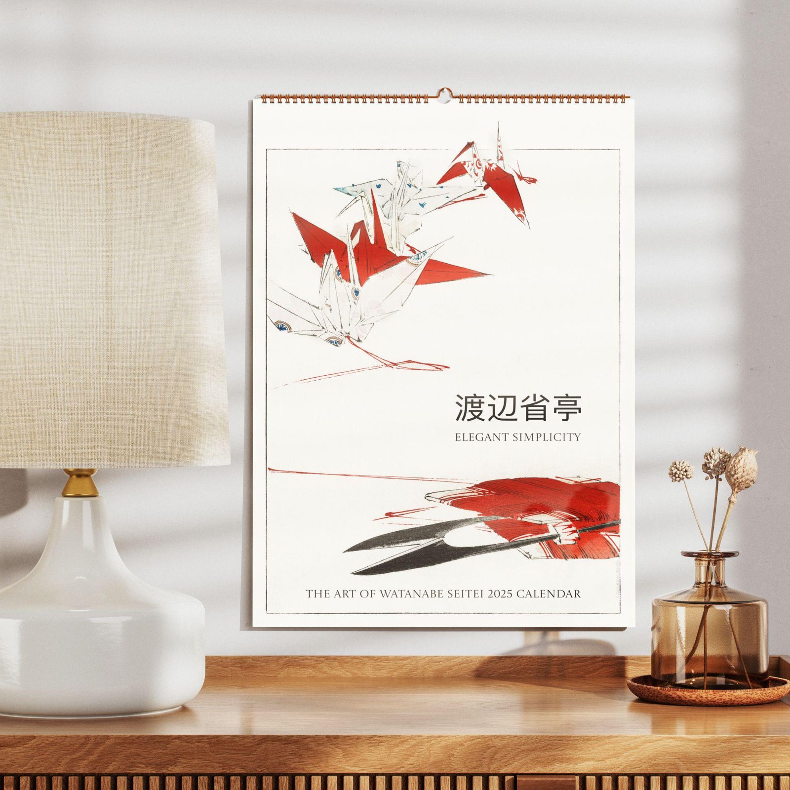 2025 Watanabe Seitei calendar on wooden desk.