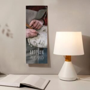 Artisan Treasures poster and desk lamp on a table.