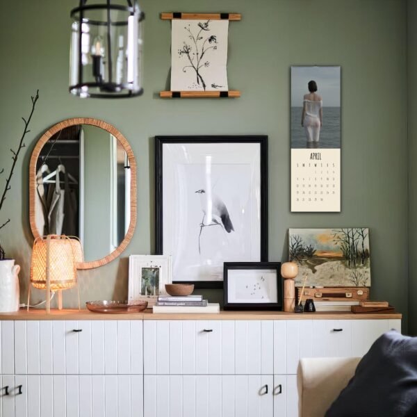 Stylish room with art, calendar, and mirror decor.
