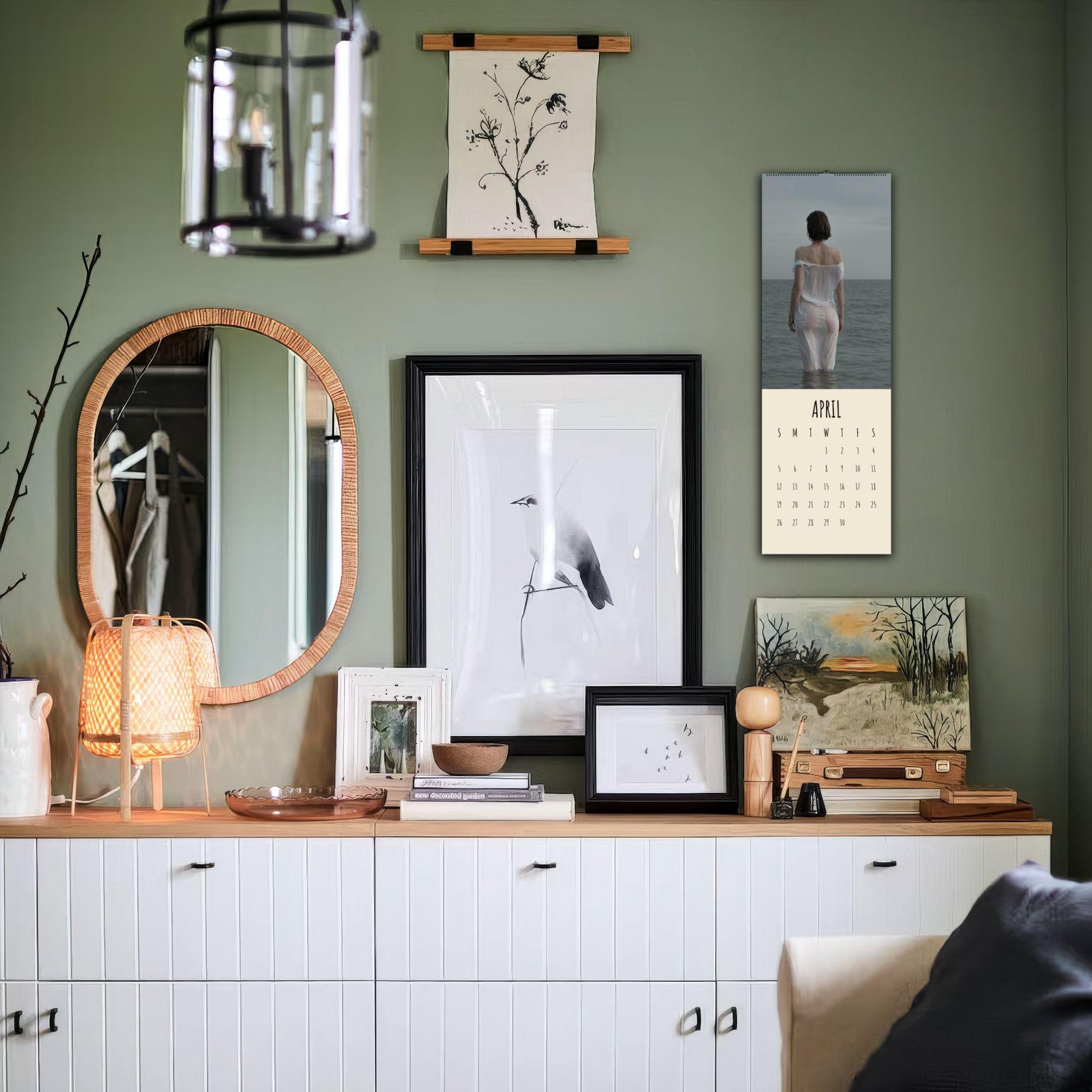 Stylish room with art, calendar, and mirror decor.