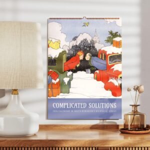 Calendar on wall above wooden shelf and lamp.