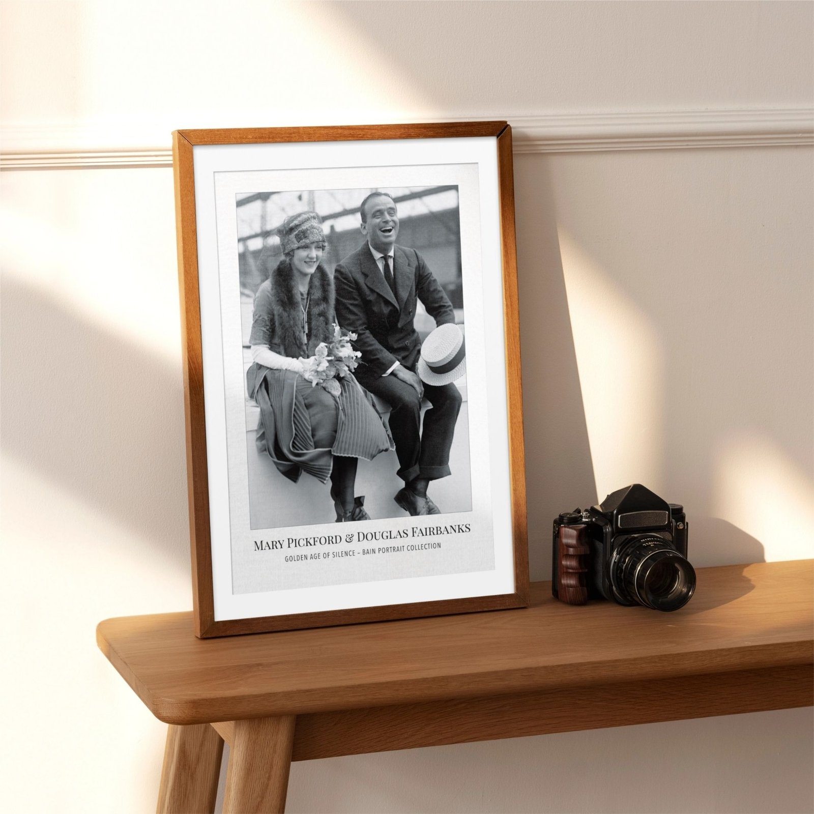 Vintage portrait photo on display next to camera.