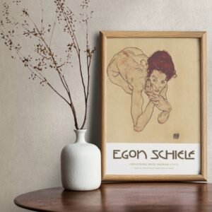 Framed Egon Schiele artwork next to white vase
