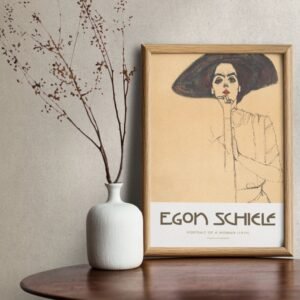 Egon Schiele artwork beside vase with branches