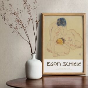 Egon Schiele framed artwork and white vase on table.