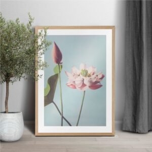 Framed lotus flower art with potted plant.