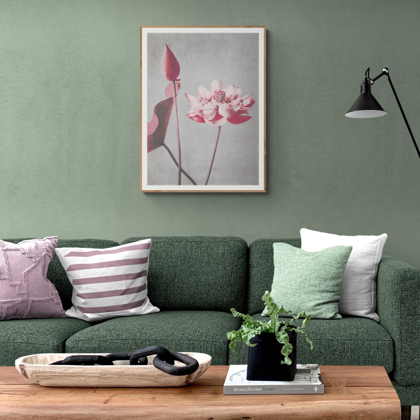 Stylish living room with green sofa and pink art