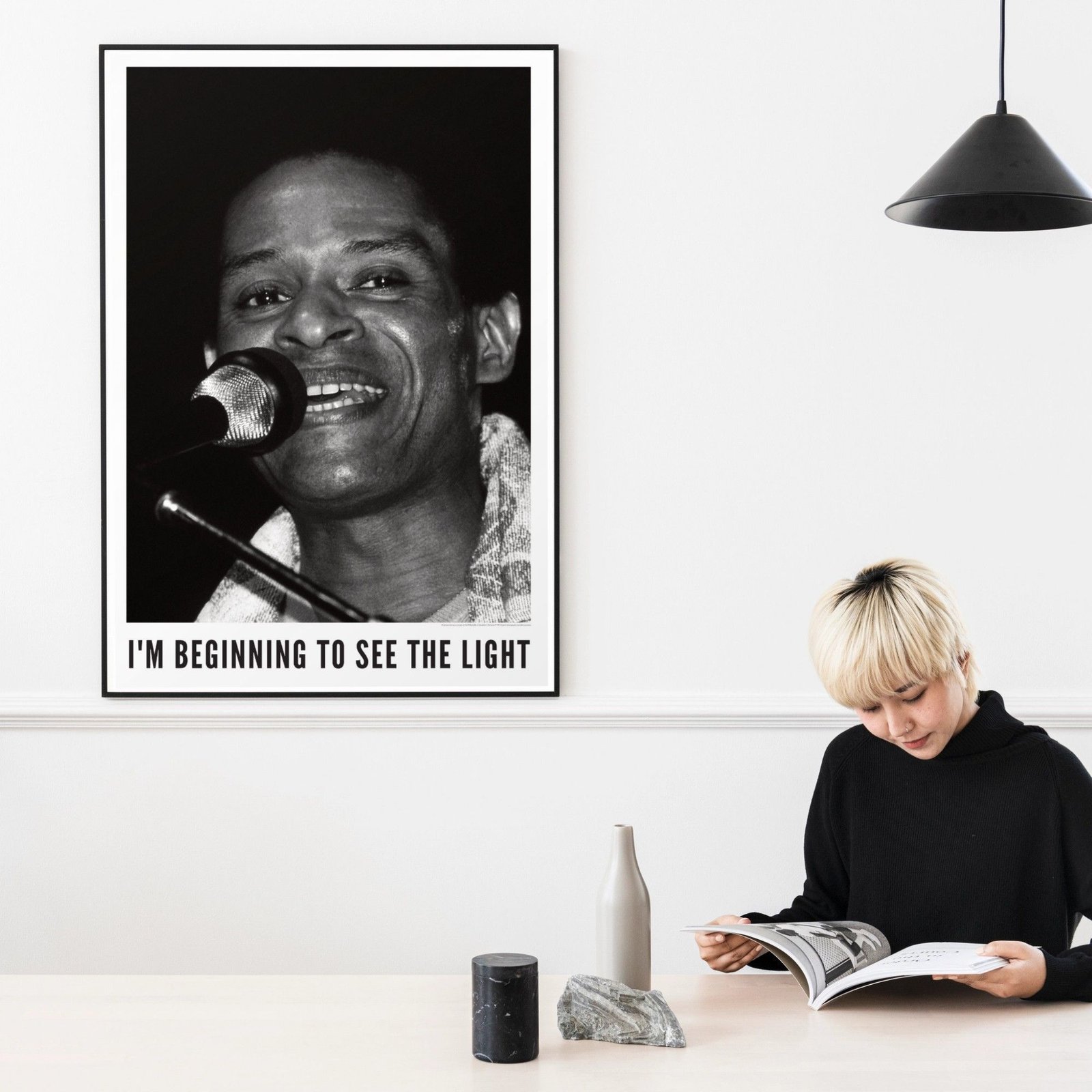 Person reading under portrait with microphone