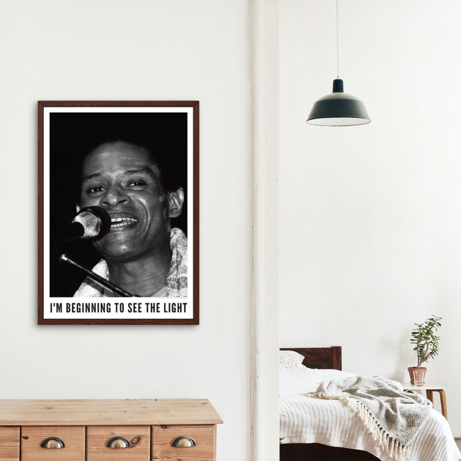 Framed poster of singer in stylish bedroom.