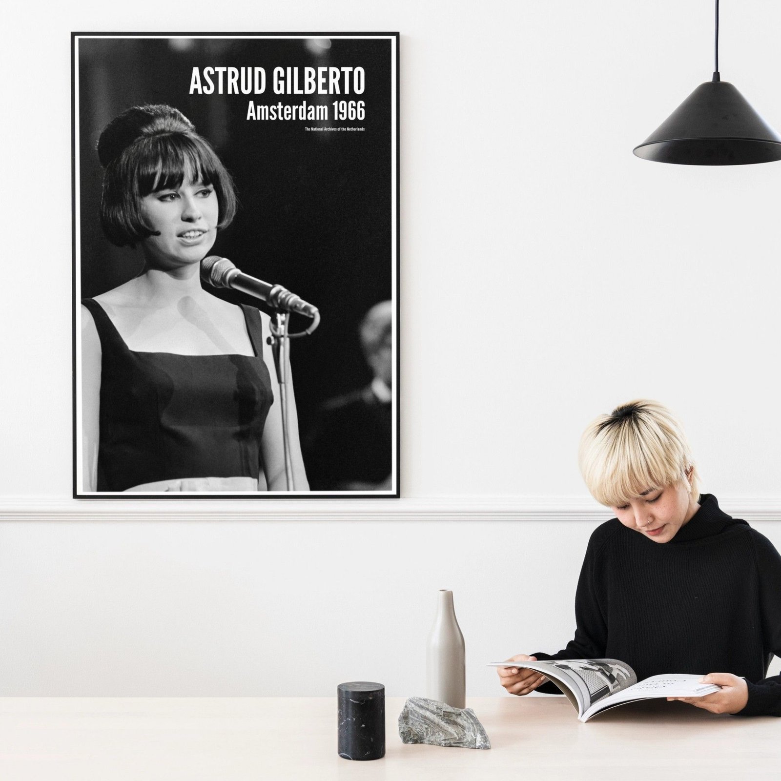 Person reading near vintage music poster.