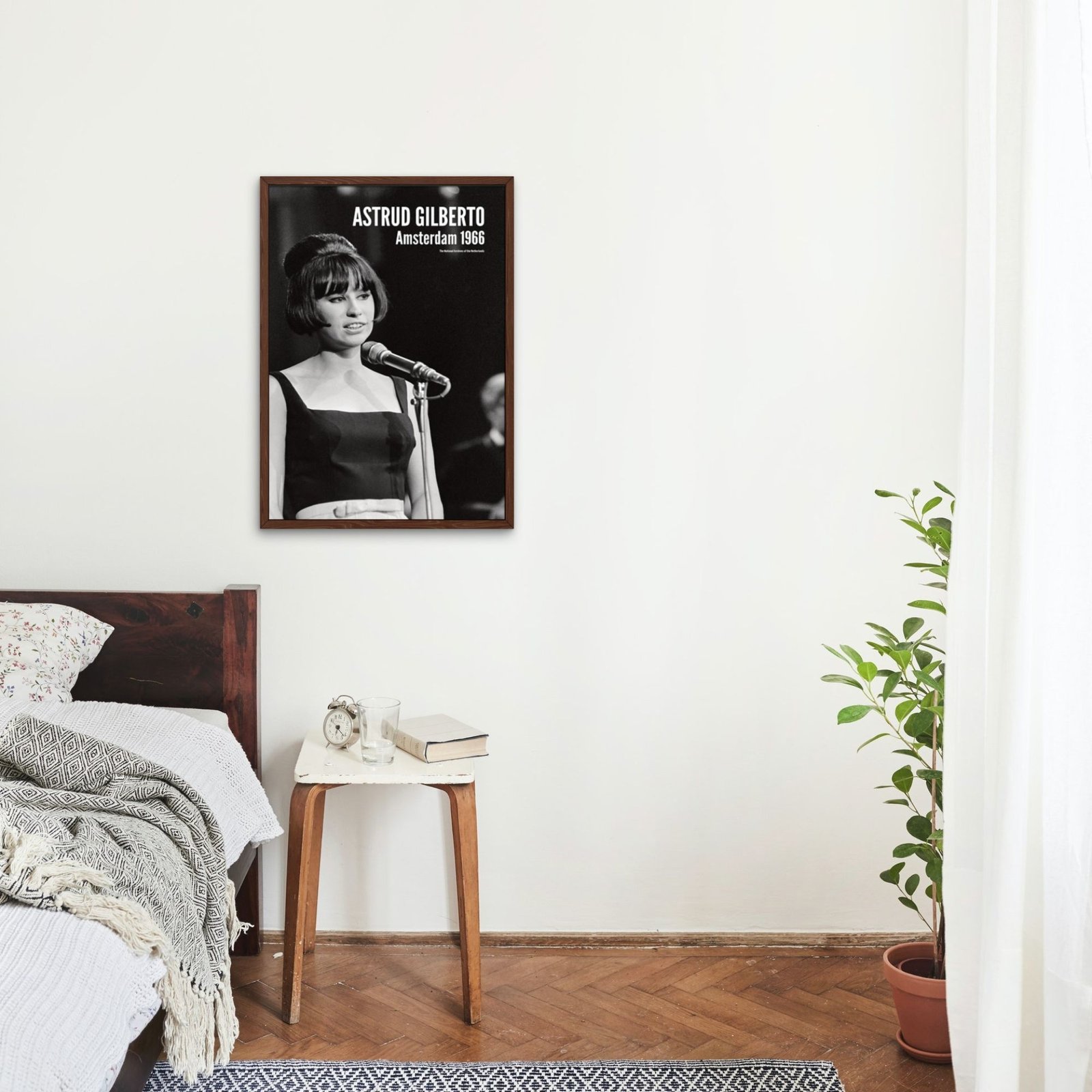 Bedroom with framed vintage concert poster on wall.